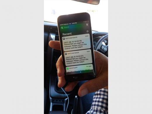 André Snyman shows off the BackApp, which sends alerts to your cellphone if someone is following you. Picture: Sarah Koning