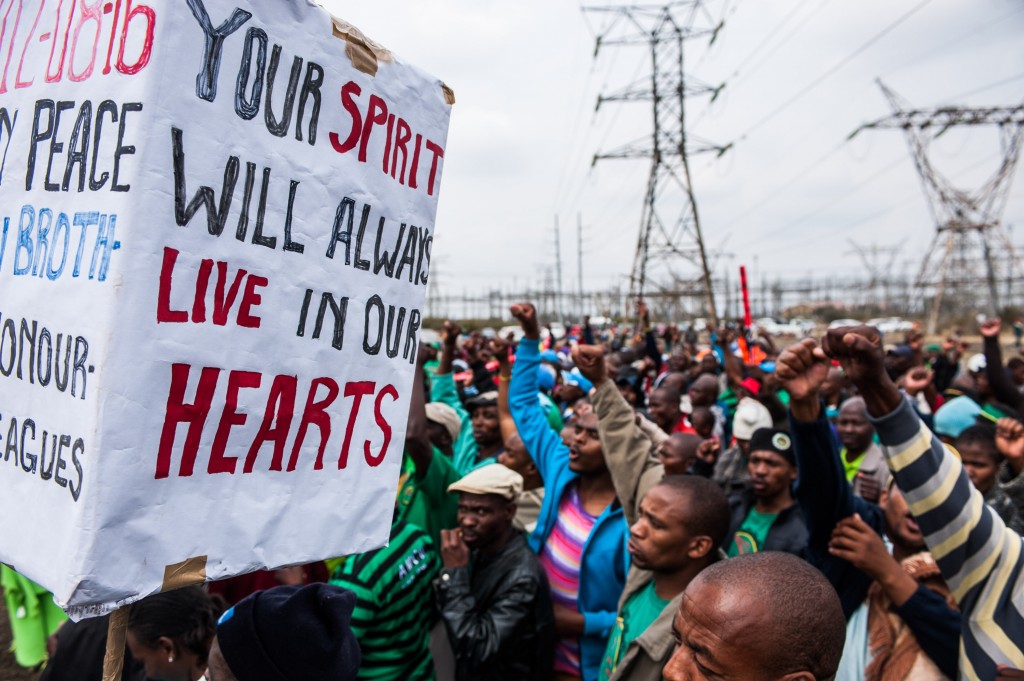 RUSTENBURG, SOUTH AFRICA - AUGUST 16: People during the commemoration rally of the second anniversary of the Marikana massacre on August 16, 2014 in Rustenburg, South Africa. Thirty-four miners were killed by police on 16 August 2012 during a violent wage increase protest. (Photo by Gallo Images / Sunday Times / Waldo Swiegers)