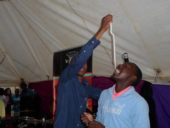 Pastor Mnguni makes his congregant eat a snake. Picture: Facebook