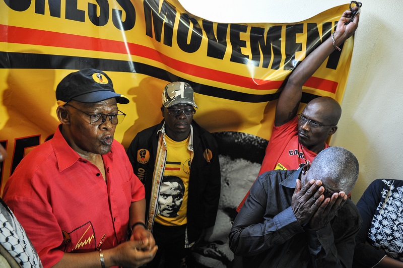 Itumeleng Mosala President of the Azanian People's Organisation (Azapo), (L) delivers a speech while, Lybon Mabasa (R) president of The Socialist Party of Azania (SOPA) and member of the Black Consciousness Movement covers his face, inside the cell where Steve Biko died on this day in 1977, 12 September 2016, Kgosi Mampuru Prison, Pretoria. Picture: Jacques Nelles