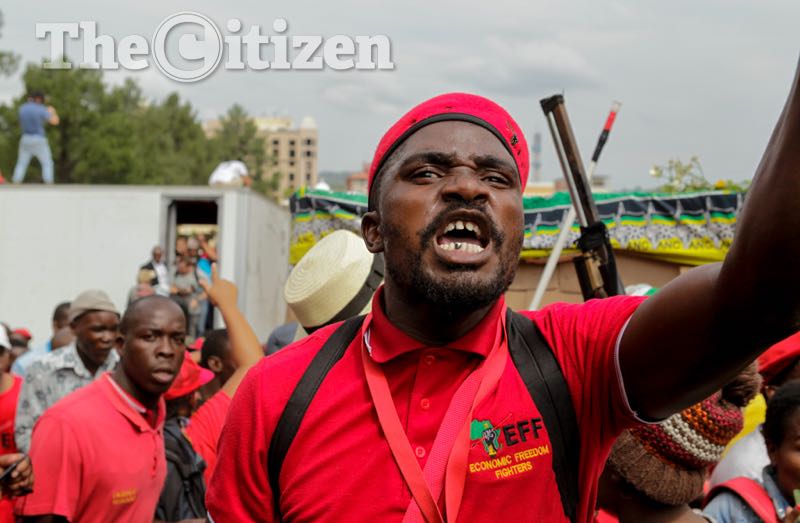 An EFF member gestures angrily towards the police line during the Day Of Action march - a civil society and opposition party protest to Union Buildings, Pretoria, against the presidency of Jacob Zuma. Picture: Yeshiel Panchia