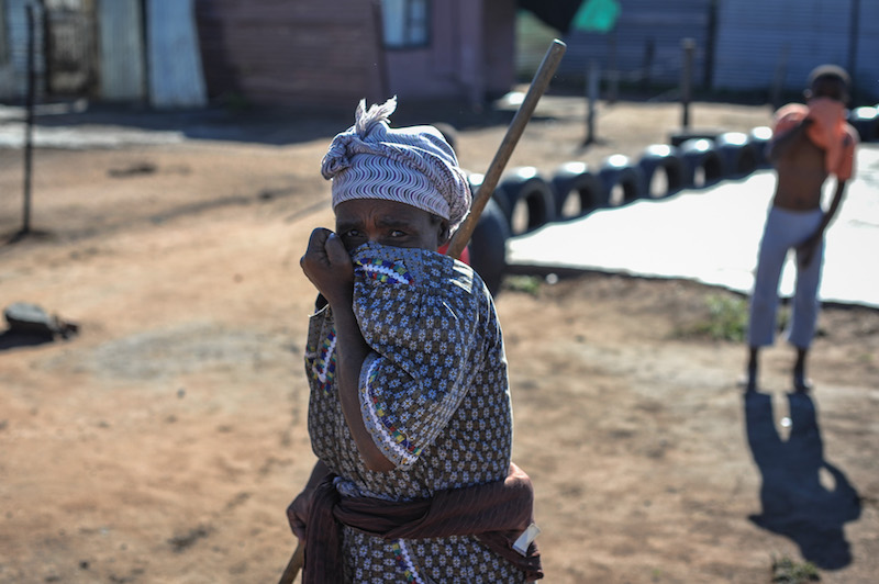 Julia Mokate (62) and her grandchild stand outside their shack after police fired tear gas near their home during a service delivery protest, protestors demanded to have proper electricity and housing and vowed to continue their protest untill their needs are met, 17 May 2017, Soshanguve, Pretoria. Picture: Jacques Nelles