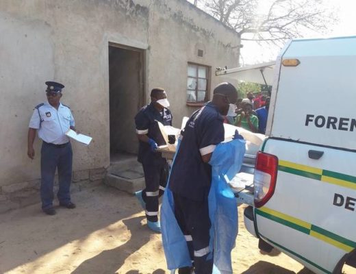 The body of the murdered mother is removed by the forensics team