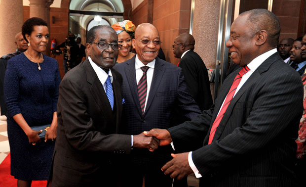 President of Zimbabwe Robert Mugabe greets Deputy President of South Africa Cyril Ramaphosa. (Photo: GCIS)