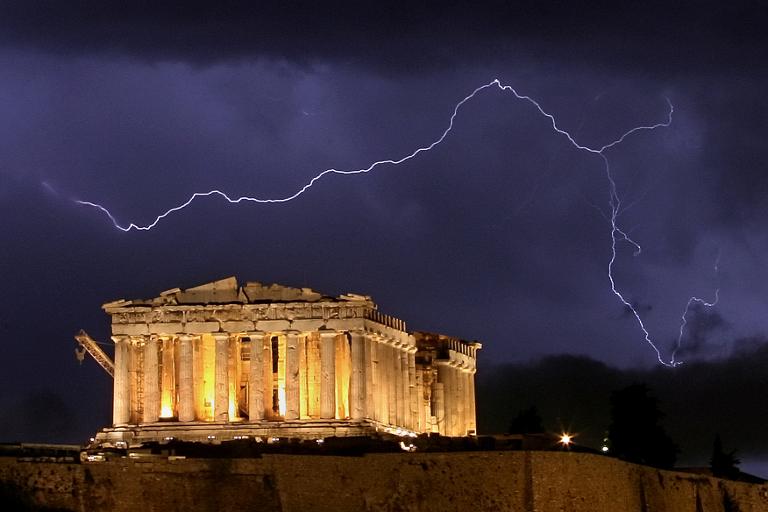 AFP/File / Aris Messinis<br />The ancient Greek Parthenon temple, atop the Acropolis hill overlooking Athens, is framed by a lightning bolt during a thunderstorm that broke out in the Greek capital in 2006