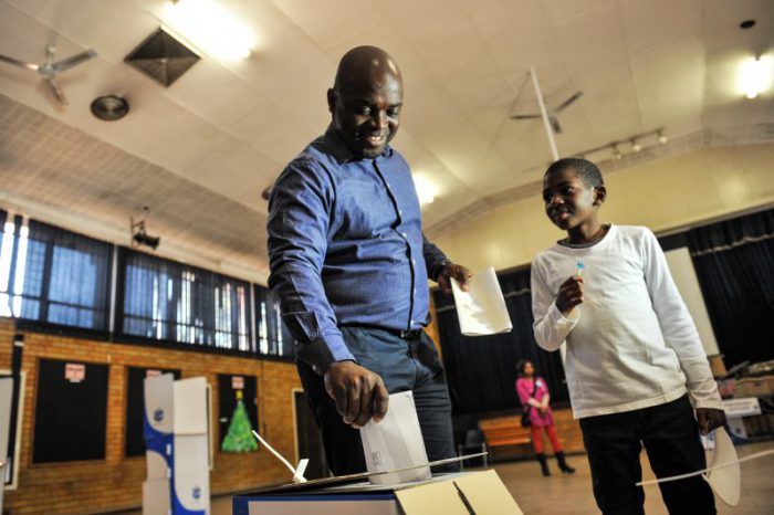 Solly Msimanga and his son dropping his vote in the ballot box at Capital Park Primary School voting station, 3 August 2016, Pretoria. Picture: Jacques Nelles