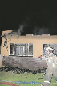 A fire fighter that came out of the house after helping to extinguish the fire.