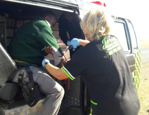 Medical personnel attend to a Fidelity security guard.