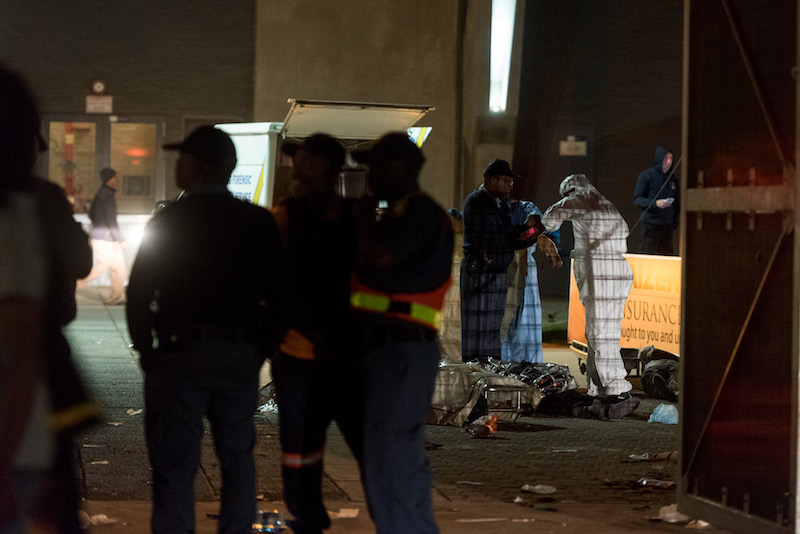 Police and forensic services work the scene around the bodies of two people who died in a stampede at the FNB Stadium in Johannesburg on 29 July, 2017. The stampede began when Kaiser Chiefs scored their first goal and people outside attempted to rush into the stadium. Picture: Yeshiel Panchia