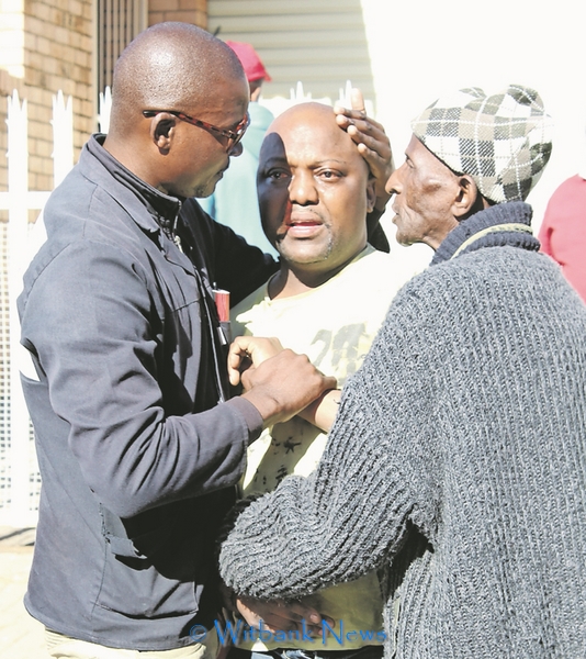 Mr Mandla Mhlanga is comforted by close family friends. Picture: Witbank News