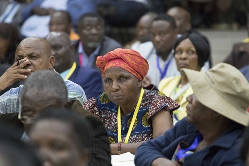 Delegates look on during the ZANU PF (Zimbabwe African National Union - Patriotic Front) party's Central Committee meeting to recall Zimbabwe's president on November 19, 2017 at the party's headquarters in Harare. Zimbabwe's president must leave office on November 19, 2017, the head of Zimbabwe's war veterans association said as pressure builds on the authoritarian leader to resign after a military takeover. / AFP PHOTO / Jekesai NJIKIZANA