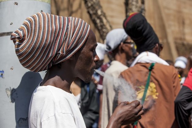 A Rastafarian smokes a joint outside the Constitutional Court on September 18, 2018 after the ConCourt has ruled that the personal use of marijuana is not a criminal offence, South Africans are allowed to smoke and grow dagga at home. Picture: Cebisile Mbonani