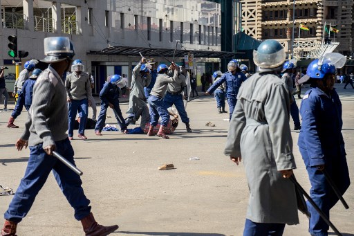 A protester is beaten on the ground by police near Unity Square in Harare on August 16, 2019. Picture: Zinyange Auntony / AFP