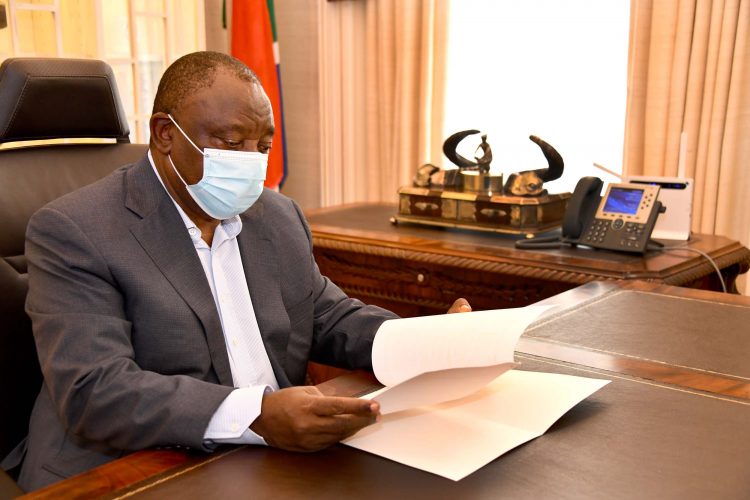 Cyril Ramaphosa reading at a desk.