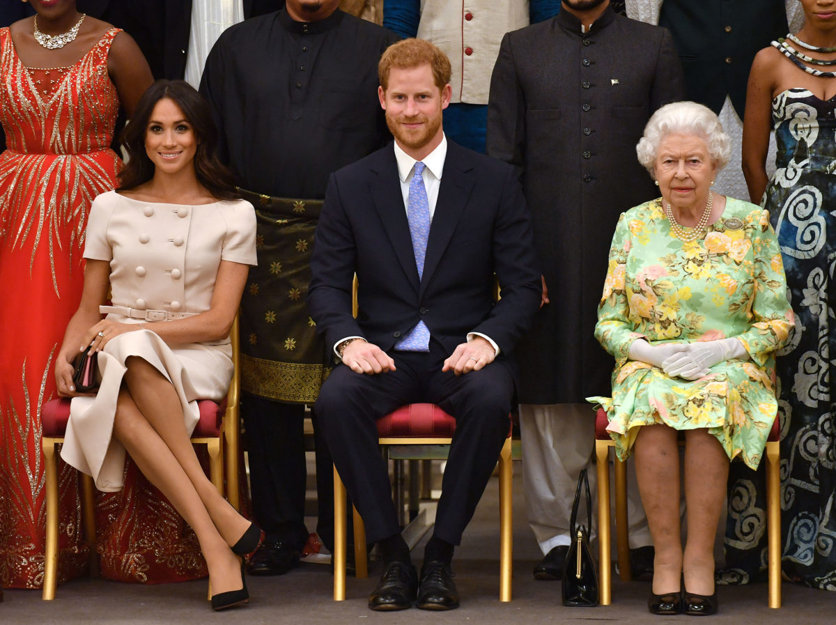 Meghan Markle poses for a picture with Prince Harry and the Queen