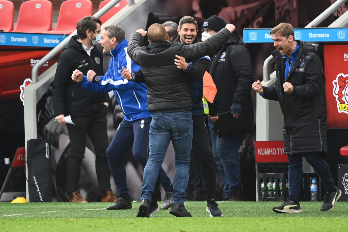 Bielefeld's German head coach Uwe Neuhaus (C) celebrates with colleagues after the end of the German first division Bundesliga football match Bayer 04 Leverkusen v Arminia Bielefeld in Leverkusen, western Germany, on March 14, 2021. (Photo by Ina Fassbender / various sources / AFP)