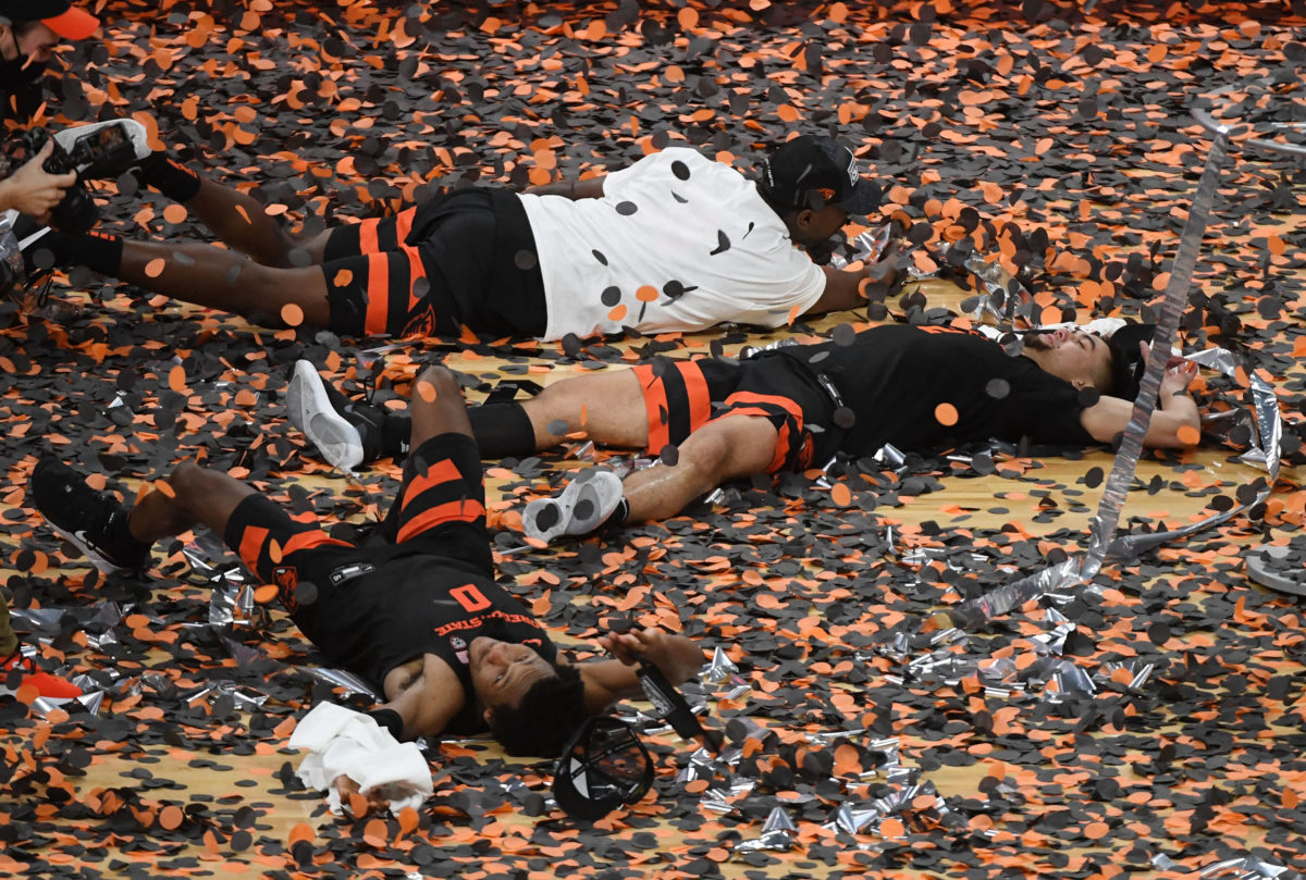 LAS VEGAS, NEVADA - MARCH 13: Gianni Hunt (bottom) #0 and Jarod Lucas (C) #2 and Dearon Tucker (top) #35 of the Oregon State Beavers celebrate in confetti after the team's 70-68 victory over the Colorado Buffaloes to win the championship game of the Pac-12 Conference basketball tournament at T-Mobile Arena on March 13, 2021 in Las Vegas, Nevada. Ethan Miller/Getty Images/AFP (Photo by Ethan Miller / GETTY IMAGES NORTH AMERICA / Getty Images via AFP)