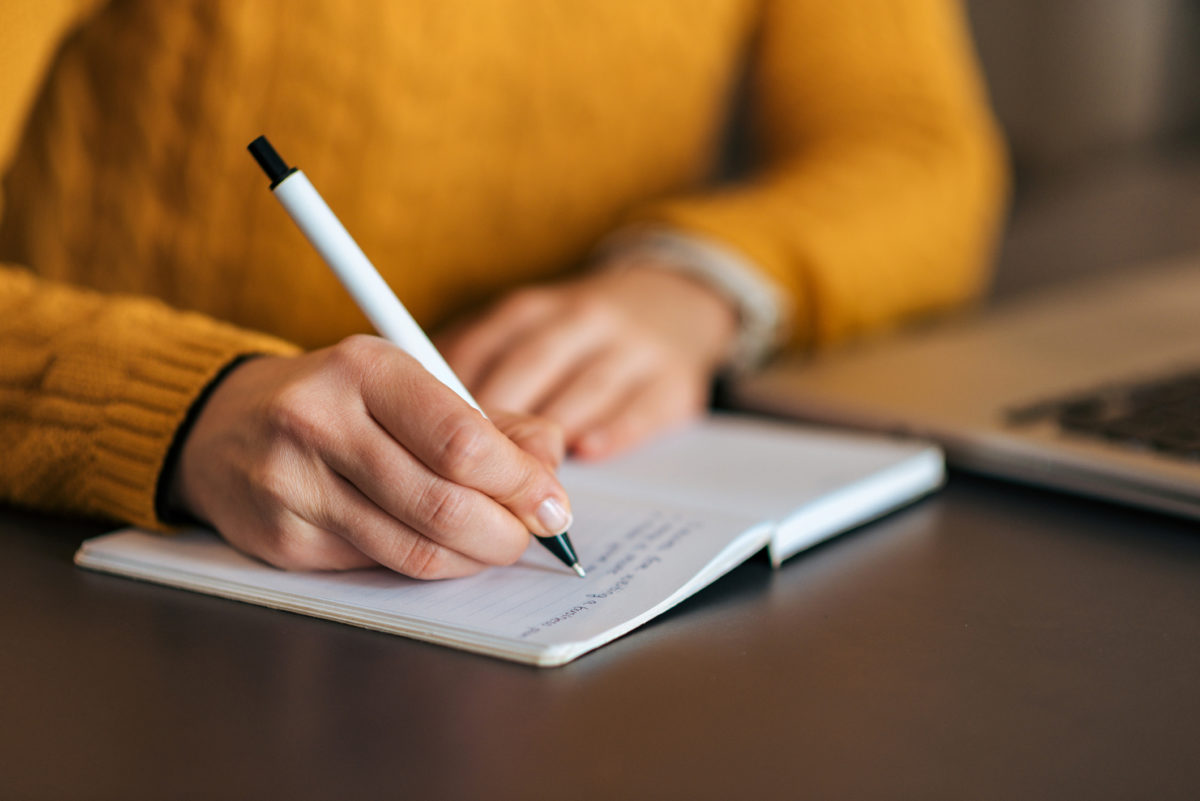 Woman writing in notebook