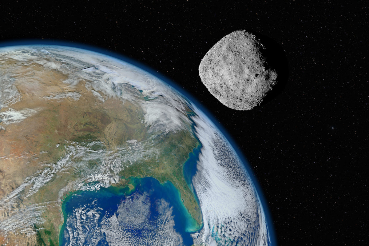 Asteroid approaching planet Earth, elements of this image furnished by NASA