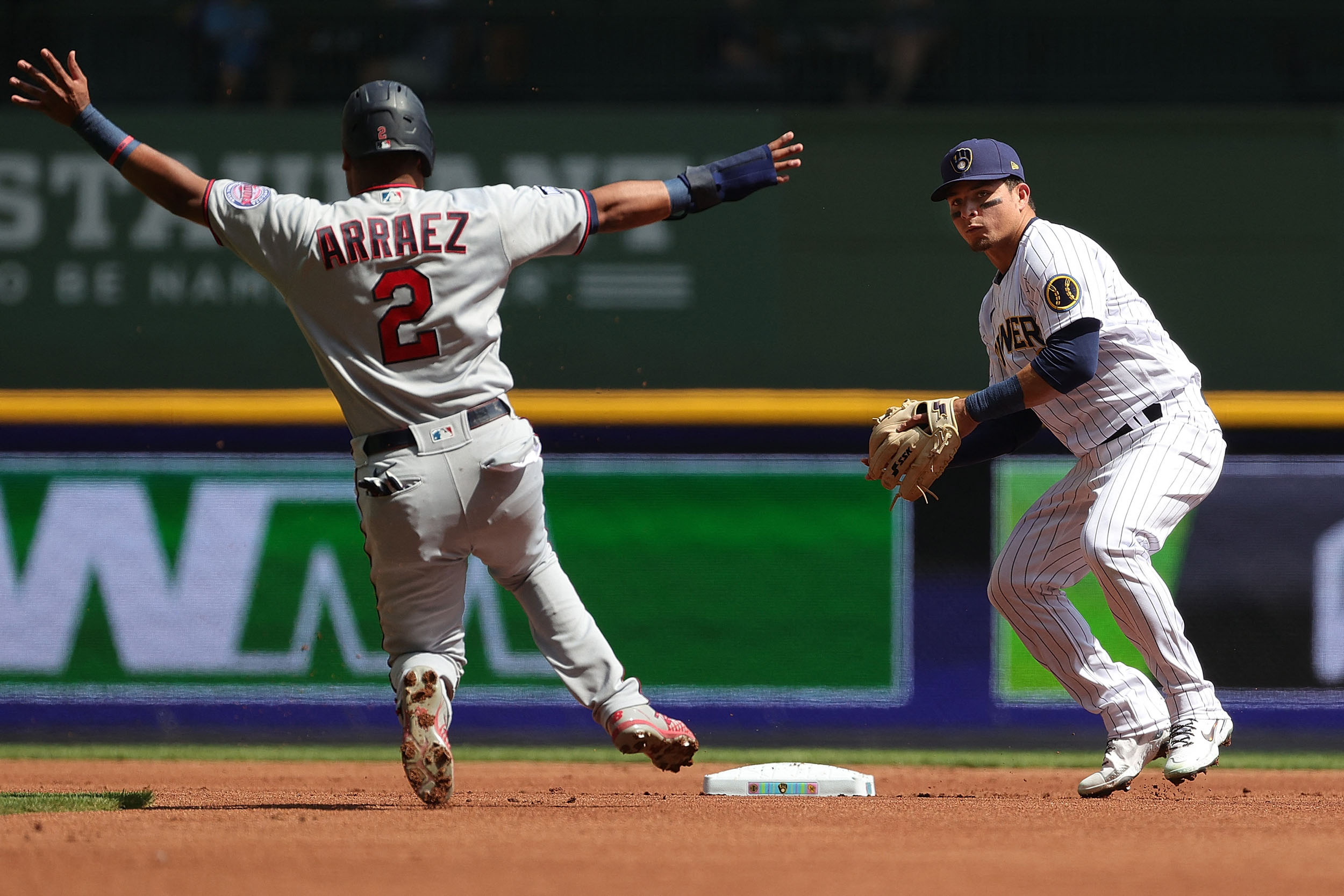MILWAUKEE, WISCONSIN - APRIL 04: Luis Arraez #2 of the Minnesota Twins is forced out at second base as Luis Urias #2 of the Milwaukee Brewers makes a throw to first base during a game at American Family Field on April 04, 2021 in Milwaukee, Wisconsin. Stacy Revere/Getty Images/AFP (Photo by Stacy Revere / GETTY IMAGES NORTH AMERICA / Getty Images via AFP)