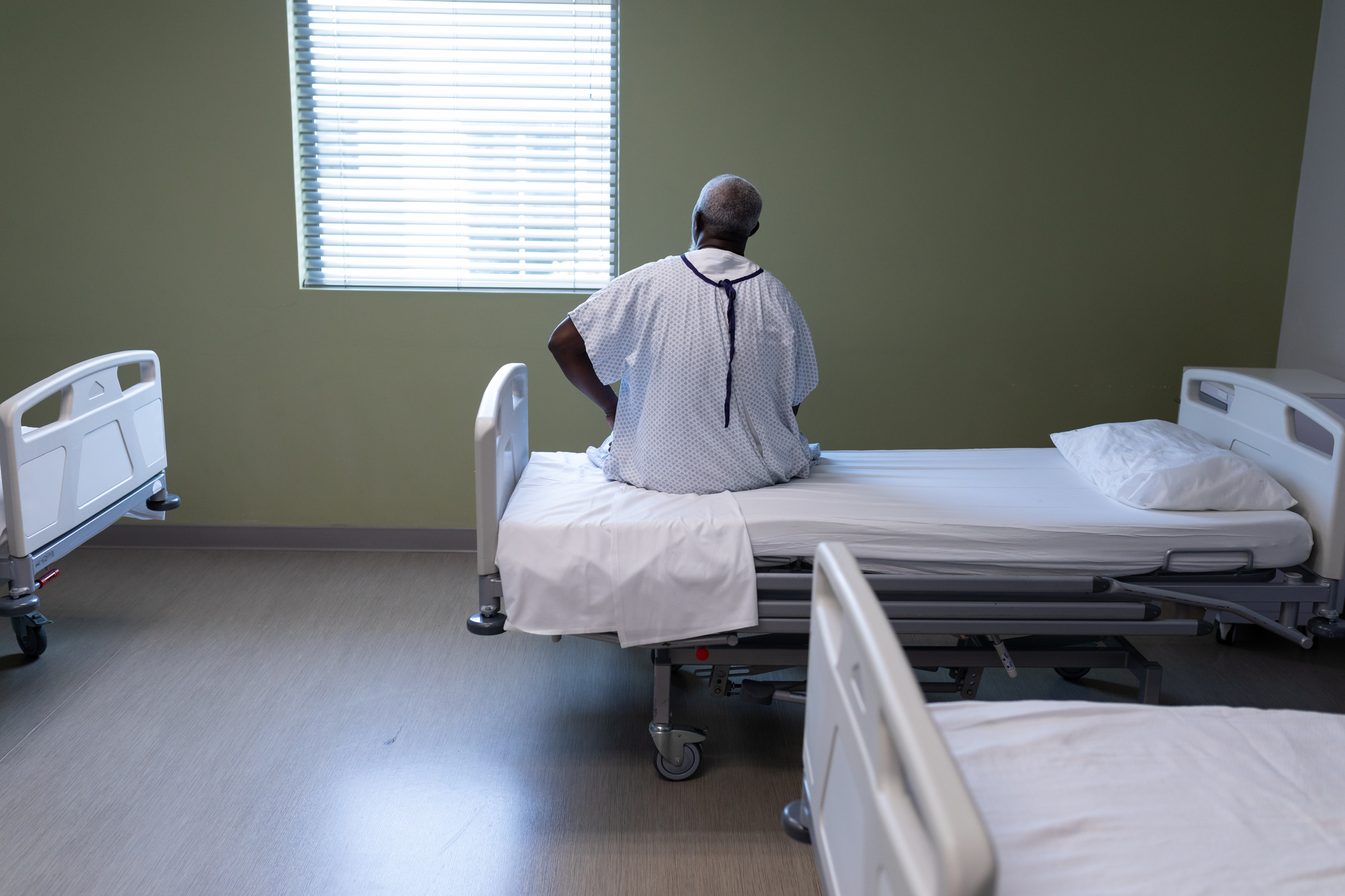 Sick man in hospital bed