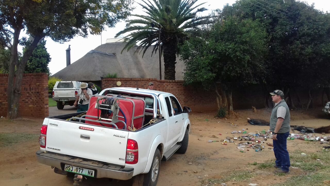 Homeowners trying to extinguish fires. Picture: Steven Tau