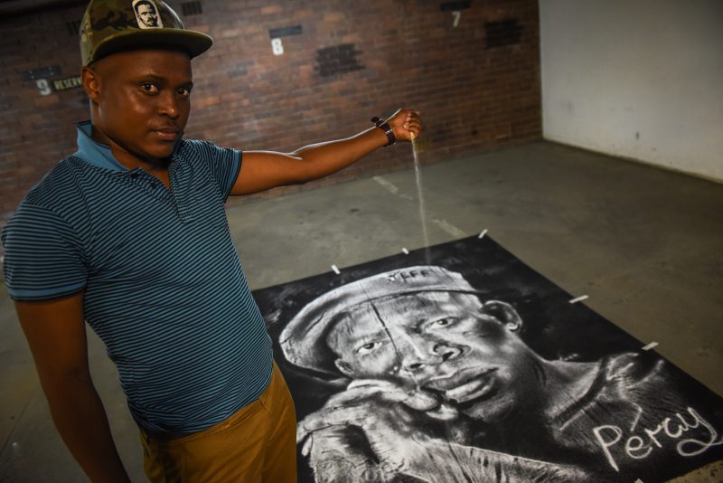 Percy Maimela poses for a picture alongside his portrait of Julius Malema made using only salt. Picture: Jacques Nelles