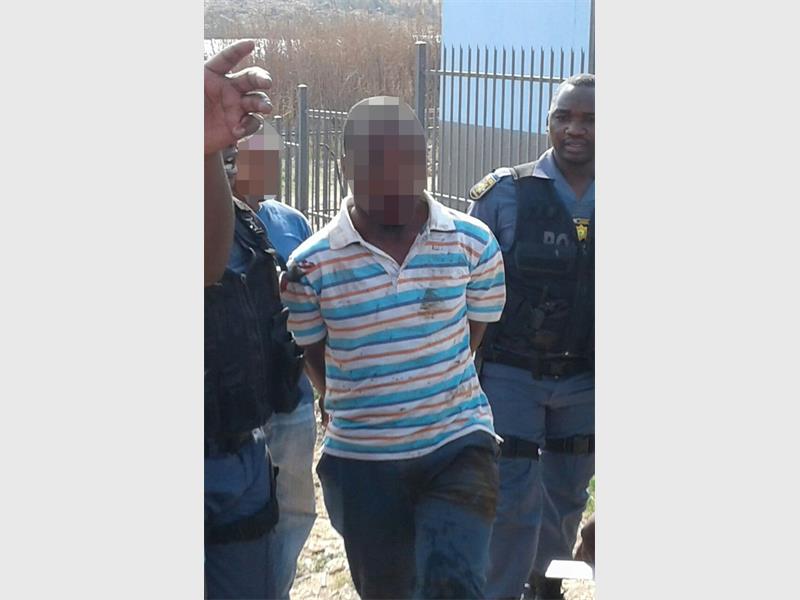 A bleeding suspect is being led to a police vehicle. (Photos supplied by Darian Kerani)