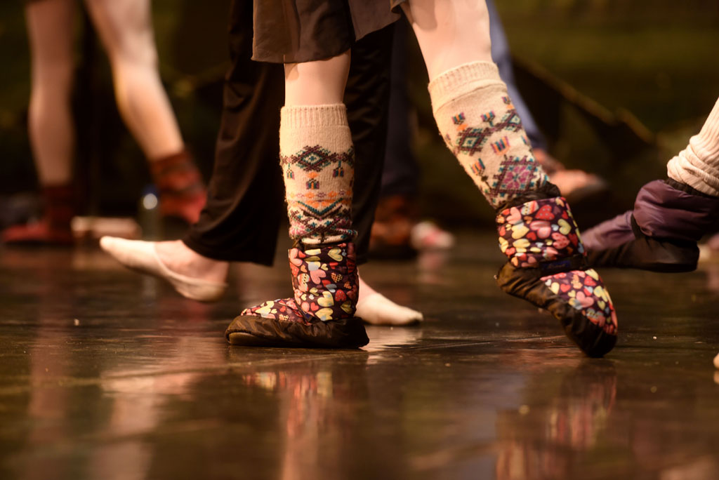 A ballet dancer keeps her feet warm while getting ready for a performance of Swan Lake. Picture: Tracy Lee Stark