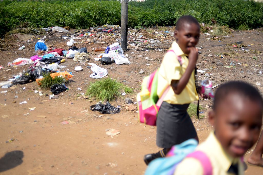 Children grow up in a garbage strewn neighbourhood in Kliptown. Picture: Tracy Lee Stark